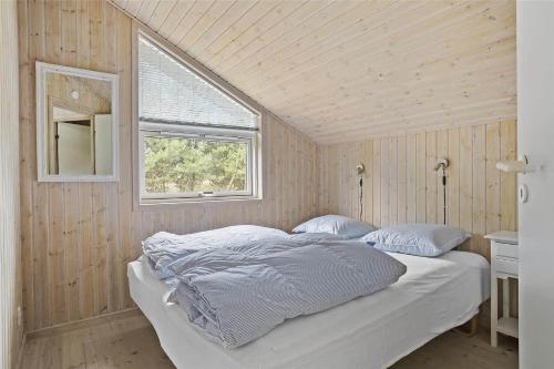 a bedroom with a bed and a window in it at TV1394-Bindslev-Rollikevej-6 in Bindslev
