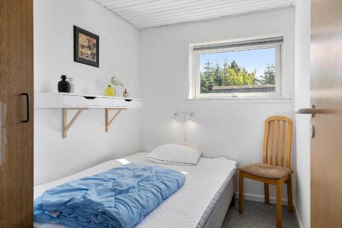 a small bedroom with a bed and a window at TV1600-Jerup-Multebaervej-33 in Jerup