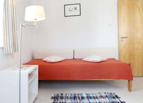 a bedroom with a bed with two pillows on it at Ferienwohnung Zum Bäckersepp in Neuschönau