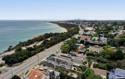 an aerial view of a city and the ocean at 4 bed beachfront home in Sandringham w Spa and sunset views in Black Rock North
