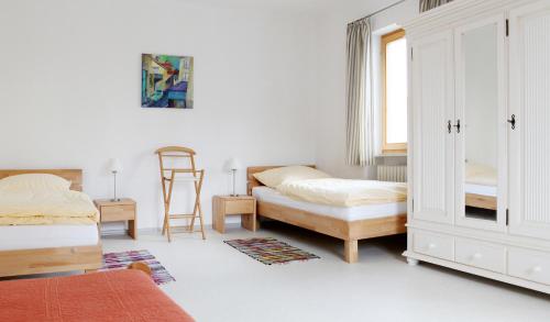 a bedroom with two beds and a window at Ferienwohnung Zum Bäckersepp in Neuschönau