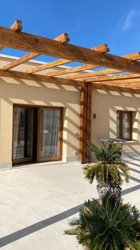 a house with a wooden pergola at La Dimora del Principe Luxury House in Mazara del Vallo