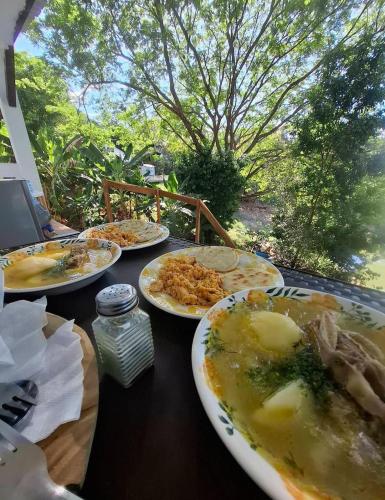 a table with plates of food on top of it at Luxury Suite del Faro, Romance en la represa in Prado
