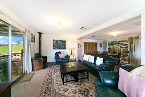 a living room with a couch and a table at Hillside Country Retreat in York