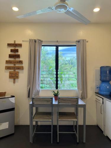 a kitchen with a table and a window at LRS Apartment in Basdiot