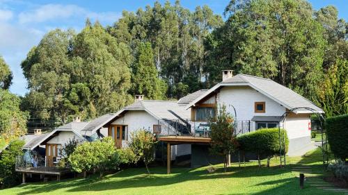 an image of a house with trees in the background at Pousada Villa Monte Verde in Monte Verde
