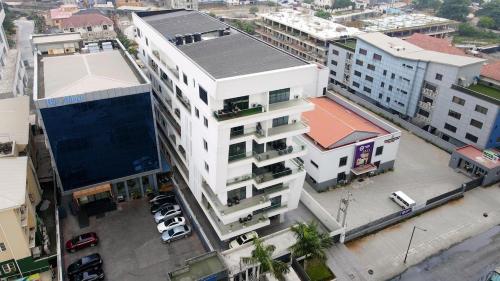 an overhead view of a white building with a parking lot at Luxury 3 bedroom penthouse with 2 living room in Lekki