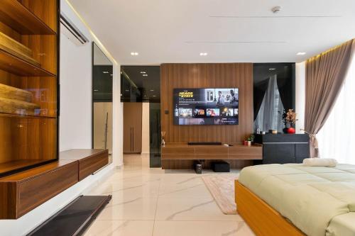 a bedroom with a bed and a desk and a television at Luxury 3 bedroom penthouse with 2 living room in Lekki