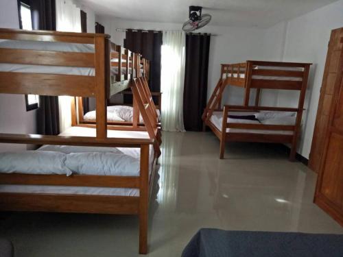 a room with several bunk beds in a room at Framelyn's Suites in Breezy Tagaytay in Tagaytay