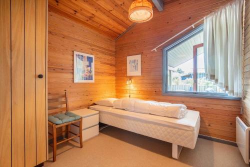 a bedroom with a bed and a window in a room at TV1542-Bindslev-Svallerhulvej-34 in Bindslev