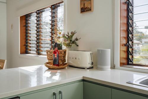 a kitchen with a counter with a toaster and a window at Oyster Catcher Huskisson in Huskisson