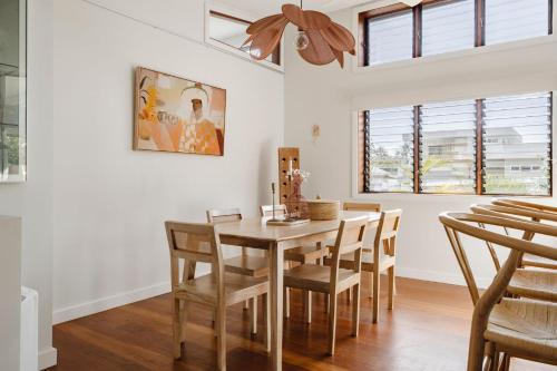 a dining room with a wooden table and chairs at Oyster Catcher Huskisson in Huskisson