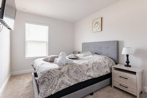 a bedroom with a bed with a stuffed animal on it at Turnkey Coastal Luxury Townhome EV Ready in Pensacola