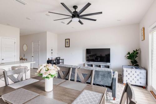 a dining room with a table and a ceiling fan at Turnkey Coastal Luxury Townhome EV Ready in Pensacola