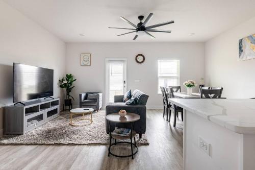 a living room with a couch and a table at Turnkey Coastal Luxury Townhome EV Ready in Pensacola