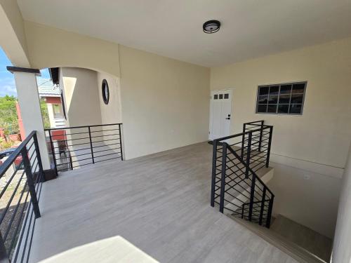 an empty room with two stairs and a door at The Luxe Paradise in Curatoe Hill