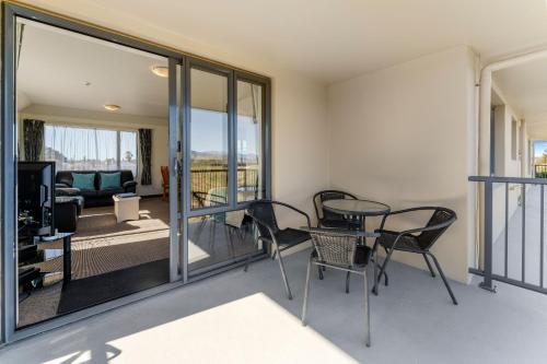 a living room with a table and chairs at Avalon Manor Motel in Motueka