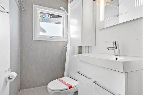 a white bathroom with a sink and a toilet at TV1308-Albaek-Zefyrvej-4 in Ålbæk