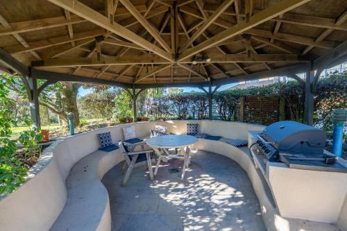 an outdoor patio with a table and a grill at Avalon Manor Motel in Motueka