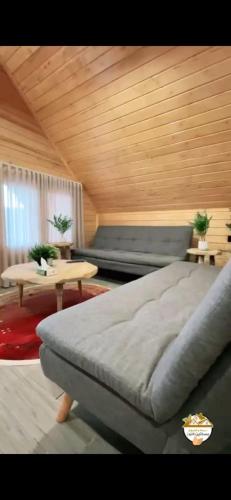 a bedroom with a large bed and a table at اكوخ في مزرعة بساتين اللوز in Quai