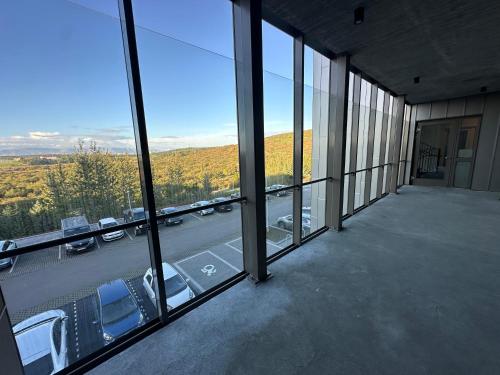a balcony with a view of a parking lot at Modern and Cozy apartment in the city next to Heiðmörk, nature reserve - Birta Rentals in Garðabær