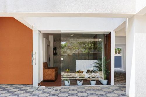 a glass doorway to a house with potted plants at Super Aarambh Exotica in Pune