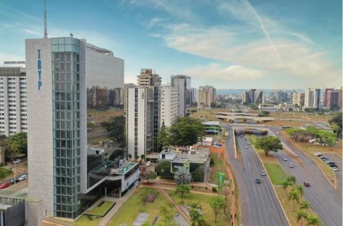 a view of a city with buildings and a street at Fabuloso Hotel das Nações - 13º Andar - Apt da Rede Premium in Brasilia
