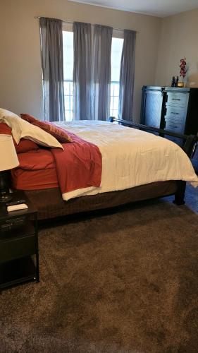 a bedroom with a bed and a dresser and a window at Cozy SFH for Active Adults in Middletown