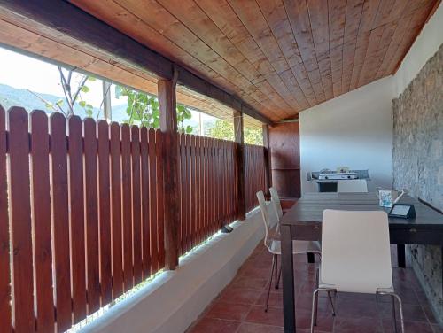 a dining room with a wooden fence and a table and chairs at Roses House in Sestri Levante