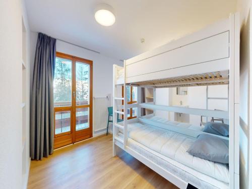 a bedroom with bunk beds in a house at Chalet with Stunning Mountain Views in Agettes