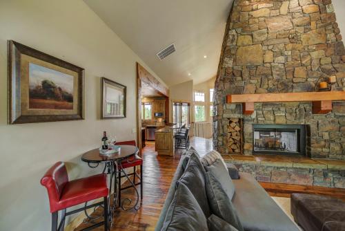 a living room with a couch and a stone fireplace at Bear Discovery Custom Tamarack Estate Home by Casago McCall - Donerightmanagement in Donnelly