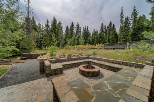 a patio with a fire pit and a fire grill at Bear Discovery Custom Tamarack Estate Home by Casago McCall - Donerightmanagement in Donnelly