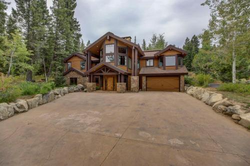 a house with a large driveway in front of it at Bear Discovery Custom Tamarack Estate Home by Casago McCall - Donerightmanagement in Donnelly