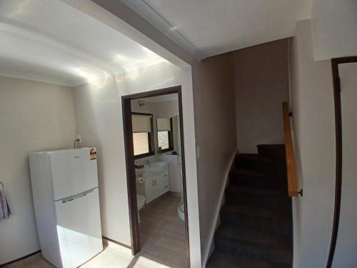 a room with a hallway with a mirror and a refrigerator at Palm City Motor Inn in Napier
