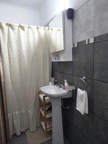 a bathroom with a sink and a shower curtain at DS confort dpto 3 in General Pico