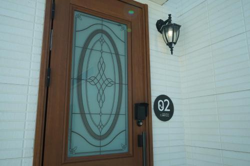 a door with a stained glass window on a house at COCO VILLA 南房総 Dog Stay in Minamiboso