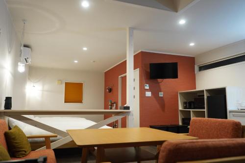 a living room with a bed and a table at COCO VILLA 南房総 Dog Stay in Minamiboso