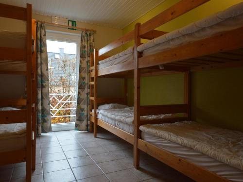 two bunk beds in a room with a window at Holiday Home in Robertville with Sauna & Garden in Robertville