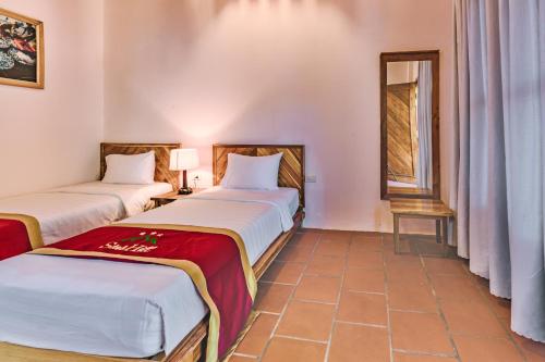 Кровать или кровати в номере Star Hill Village Phu Quoc
