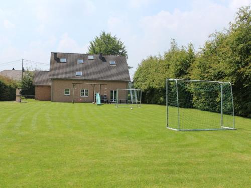a yard with two soccer nets and a house at Holiday Home in Robertville with Sauna & Garden in Robertville