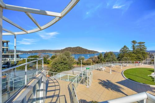 a balcony with a view of a park at Ettalong Beach Luxury Apartments in Ettalong Beach