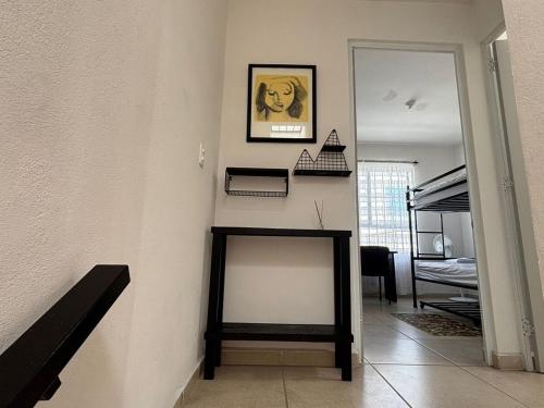 a room with a wall with a picture of a dog on the wall at CASALUNA frente alberca AirAc in Atlacholoaya