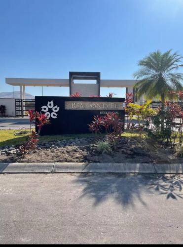 a sign in front of a gas station at CASALUNA frente alberca AirAc in Atlacholoaya