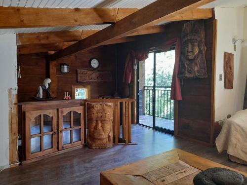 a living room with a large head on the wall at collico lodge in Villarrica