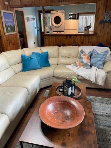 a living room with a white couch and a table at Algonquin Waterfront and Winter Paradise With Sunsets in Algonquin Highlands