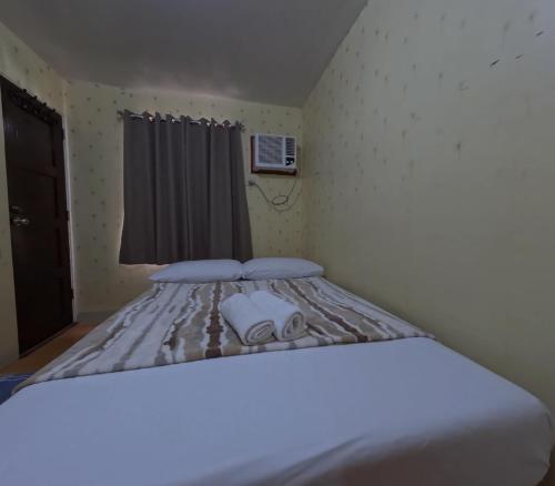 a bedroom with a bed with two towels on it at Cozy 2br deca homes near sm jmall in Mandaue City