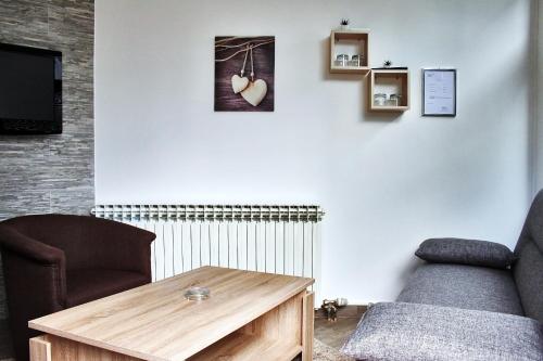 a living room with a couch and a coffee table at Rooms Fitea in Osijek