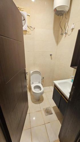 a bathroom with a toilet and a sink at همم للوحدات السكنيه المخدومة- الدقم in Umm Lujj