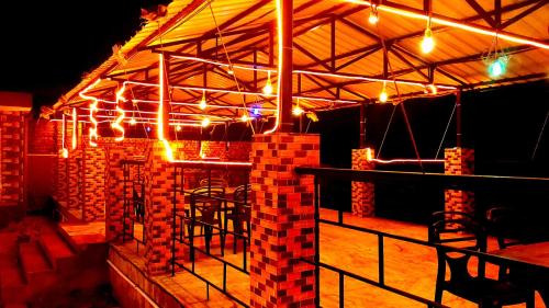 a room with a bar with lights on it at Sonargaon Beach Resort in Mandarmoni