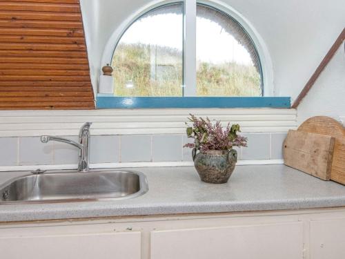 a kitchen counter with a sink and a window at 3 person holiday home in Ringkøbing in Ringkøbing